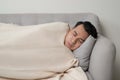 Asian eldely sick man feel headache lying on the sofa at home Royalty Free Stock Photo