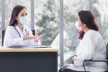 Asian elder female consults with professional doctor about her symptom or health problem in examination room at hospital Royalty Free Stock Photo