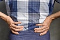 Asian elder man suffering from back and loin pain. It can be caused by renal stone