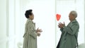 Asian elder senior couple thrown red heart balloon give and receive love marriage life secret Royalty Free Stock Photo