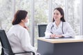 Asian elder woman consults with doctor about her symptom or health problem in examination room at hospital Royalty Free Stock Photo