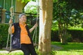 asian elder woman relaxing resting on swing in garden. elderly s