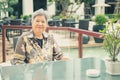 Asian elder woman resting relaxing on balcony terrace. elderly senior leisure lifestyle