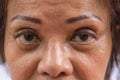 Asian elder women show her eyes and eyebrow tattoo Royalty Free Stock Photo