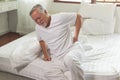 Asian Elderly back pain and sit in bedroom