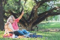 Asian elderly couple, attractive wife and husband, picnic and relaxing on the green lawn Royalty Free Stock Photo