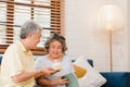 Asian elderly couple man holding cake celebrating wife`s birthday in living room at home. Japanese couple enjoy love moment Royalty Free Stock Photo