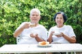 Asian elderly couple sitting in the morning drinking coffee Royalty Free Stock Photo