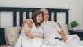 Asian elderly couple watching television in bedroom at home, Asia couple enjoy love moment while lying on the bed when relaxed at Royalty Free Stock Photo