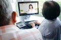 Asian elderly couples using computers Online video calling Talk to the doctor from home to inquire about health problems. Royalty Free Stock Photo