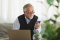 Asian Elderly man use cradit card shopping online Royalty Free Stock Photo