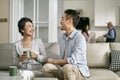 Asian elderly mother and visiting adult son chatting at home Royalty Free Stock Photo