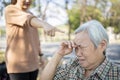 Asian elderly people crying while young caregiver scolding,angry annoyed woman getting mad pointing finger to senior woman, girl Royalty Free Stock Photo