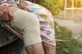 Asian Elderly people or older woman wearing the knee support or athlete knee strap to decrease knee pain,healthy concept Royalty Free Stock Photo