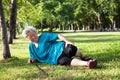 Asian elderly people with walking stick on floor after falling down in summer outdoor park,sick senior woman fell to the floor