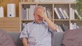 Asian elderly seniority man got headache and migraine. Old man got pain and illness on couch alone at home. Thoughtful, stressed