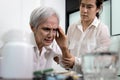 Asian elderly suffering from headache,painful cranial neuropathies,facial pains,stressed senior woman with tension type headache,