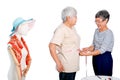 Asian elderly tailor woman show action of body measurement for the other elderly customer near cloth puppet. Image is isolated on