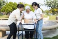 Asian elderly use walker during rehabilitation for safety after knee surgery,daughter,granddaughter help,care,support her senior