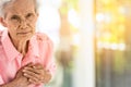 Asian elderly woman with certain symptoms,difficulty breathing,suffering or heart problems,Communicates the symptoms of heart Royalty Free Stock Photo