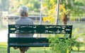 Asian elderly woman depressed and sad sitting back on bench in autumn park Royalty Free Stock Photo