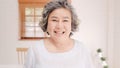 Asian elderly woman feeling happy smiling and looking to camera while relax on the sofa in living room at home. Lifestyle senior Royalty Free Stock Photo