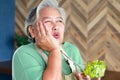 Asian elderly woman having toothache after eating. Elderly dental health problems. Royalty Free Stock Photo