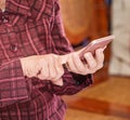 Asian elderly woman sitting and looking through something on modern smartphone, making connection with others at home, living