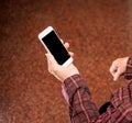 Asian elderly woman sitting and looking through something on modern smartphone, making connection with others at home, living Royalty Free Stock Photo