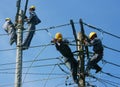 Asian electrician climb high, work on electric pole