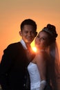 Asian elegance wedding couple ourdoor with sunset backgound Royalty Free Stock Photo