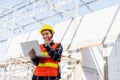 Asian engineer architect worker woman working at build construction site use laptop and talking with radio Royalty Free Stock Photo