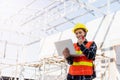 Asian engineer architect worker woman working at build construction site use laptop and talking with radio Royalty Free Stock Photo