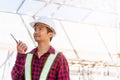 Asian engineer foreman architect worker man working at building construction site talking with radio Royalty Free Stock Photo