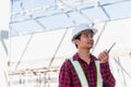 Asian engineer foreman architect worker man working at building construction site talking with radio Royalty Free Stock Photo