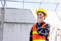 Asian engineer foreman architect worker woman working at building construction site talking with radio Royalty Free Stock Photo