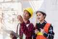 Asian engineer foreman worker man and woman working at building construction site Royalty Free Stock Photo