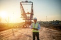 Asian engineer with hardhat using tablet pc computer inspecting and working at construction site Royalty Free Stock Photo