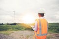 Asian engineer with hardhat using tablet pc computer inspecting