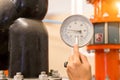 Asian engineer maintenance checking technical data of  system equipment Condenser Water pump and pressure gauge , chiller water Royalty Free Stock Photo