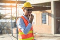 Asian engineer using radio to command to labour team in site construction Royalty Free Stock Photo