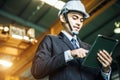 Asian engineer man wearing white helmet and using tablet Royalty Free Stock Photo