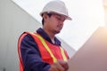 Asian engineer in safety uniform holding project plan Royalty Free Stock Photo