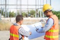 Asian engineer using radio to command to labour team in site construction Royalty Free Stock Photo