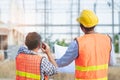 Asian engineer using radio to command to labour team in site construction Royalty Free Stock Photo