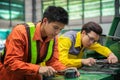 Asian engineer and worker setting machine