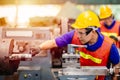 Asian engineer worker using Vernier Caliper to check size for accuracy precision quality control of service machine in factory Royalty Free Stock Photo