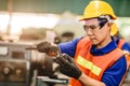 Asian engineer worker using Vernier Caliper to check size for accuracy precision quality control of service machine in factory Royalty Free Stock Photo