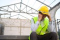 Asian Engineering man with safety helmet feeling sad in construction site