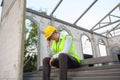 Asian Engineering man with safety helmet feeling sad in construction site